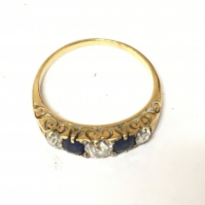 A yellow metal sapphire and diamond ring. Size R and 3.35g