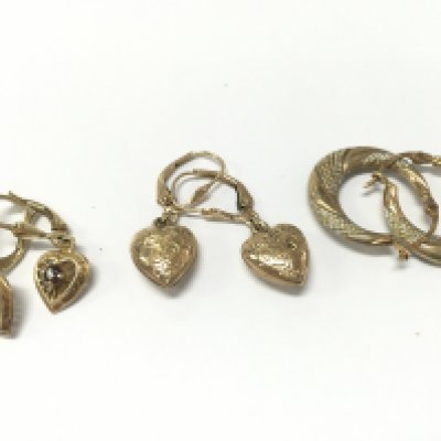 Three pairs of earrings 9ct and 10k. 5g total weight. Also includes some charms some being 9ct and a 9ct gold heart padlock charm . Postage category A