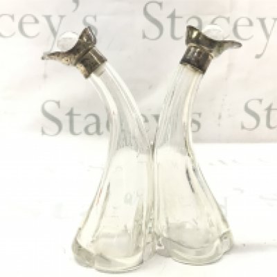 A Oil And Vinegar glass and silver hallmarked cruet , marked Birmingham 1912.17cm tall. This lot cannot be posted