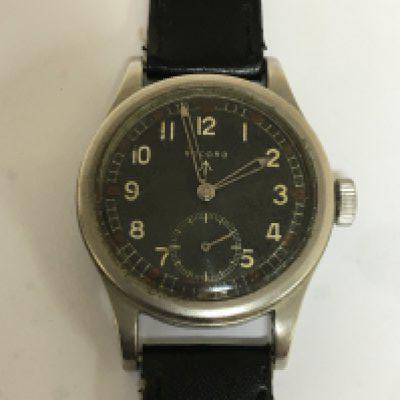 A Good Example of II world war British Military issue watch known as The Dirty Dozen maker Record the black dial with illuminated batons military symbol and second subsidiary dial seen working. The reverse with model and serial numbers L33265 551112.