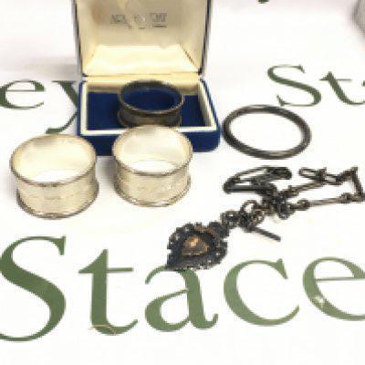 A small collection of silver items including Napkin rings, Pendants, watch chain etc. postage category B