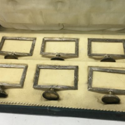 A cased set of six silver card holders marked 900 ( one damaged ) .