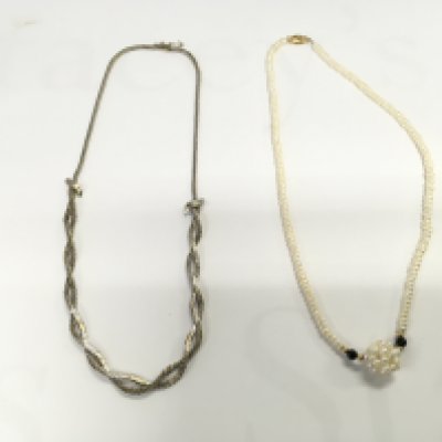 Two necklaces including a pearl necklace and a white metal one. Postage A