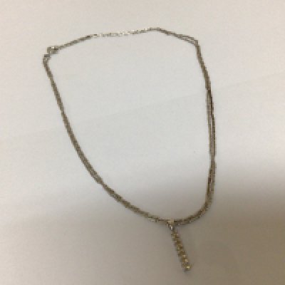 A 9carat white gold necklace with an unmarked modern design vertical drop pendent attached length of chain 76cm approximately weight 5.9g approximately.