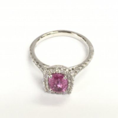 Platinum ring set with oval pink sapphire surrounded by diamonds and further diamonds set in shoulders. Sapphire 1.24ct and diamonds 0.41ct. Size N 1/2 approximately.