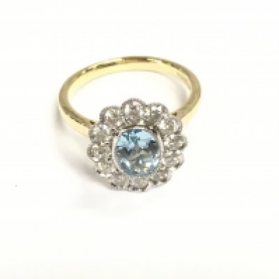 9ct yellow and white gold oval Swiss blue topaz and diamonds daisy cluster ring with scalloped finish. Topaz 1.40ct and diamonds 0.98ct size P.