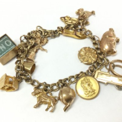 A 9ct gold charm bracelet , 26.1g total weight postage category A