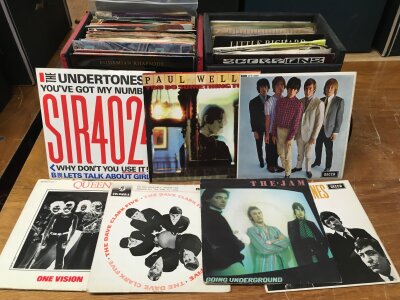 Eight record cases of 7" singles and EPs by various artists including Paul Weller, The Undertones, The Cure, Kraftwerk and many more.