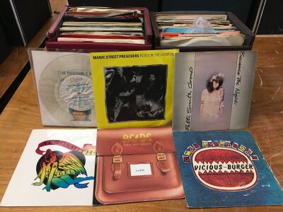 Eight record cases of 7" singles and EPs by various artists including Manic Street Preachers, Patti Smith, AC/DC, Jimi Hendrix and many more.