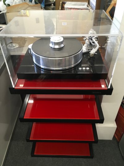 A Pro Ject Signature 10 high end turntable fitted with a Gold Note Donatello cartridge. Comes with all accessories and transportation box. This is sold with a stylish NorStone red and black HiFi stand.