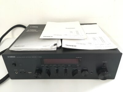 A Yamaha R-N602 receiver and a pair of Tannoy 6.4 precision floor standing speakers, dual concentric with a high gloss dark walnut finish (3). Comes with manuals.