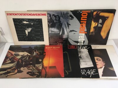 Two bags containing eighteen LPs by various artists including Lou Reed, David Bowie, Sparks and others.