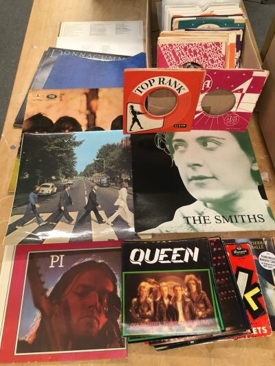 A box of spare company sleeves and record covers, Dark Side Of The Moon poster etc.