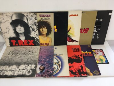 Twelve LPs by various artists including T Rex, Bob Marley and others.