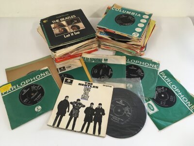 A collection of 7" singles and EPs by various artists including The Beatles, The Monkees, Elton John and others.