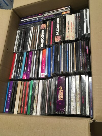 Four boxes of CDs, mainly Madonna but also including Amy Winehouse, Adele, Bon Jovi and many more, comprising many sealed examples.