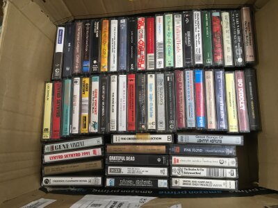 Two boxes of cassettes by various artists comprising The Beatles, Pink Floyd, Beck, Blur, Grateful Dead and many more plus three Rolling Stones 8 track cartridges.