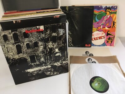 A record case of LPs by various artists including The Beatles, Rolling Stones, Elton John and others.