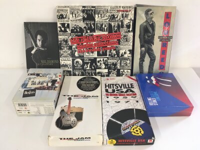 A collection of CD and DVD box sets by various artists including The Rolling Stones, The Jam and others.