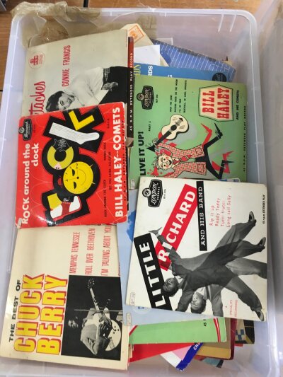 A box of 7" singles and EPs by various artists from the 1950s onwards.