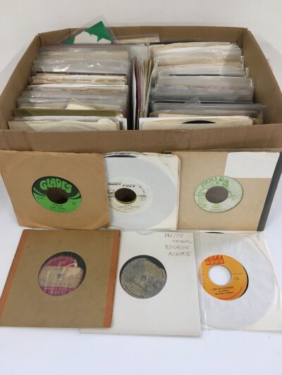 A box of 7" singles including reggae artists comprising UK, US and Jamaican pressings, acetates, demo discs etc.