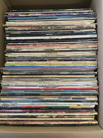 A box of LPs by various artists including Genesis, Elton John, Alan Hull and others.