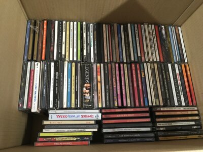 Four boxes of CDs by various artists including Oasis, The Hives, Def Leppard, The Cure and many more.