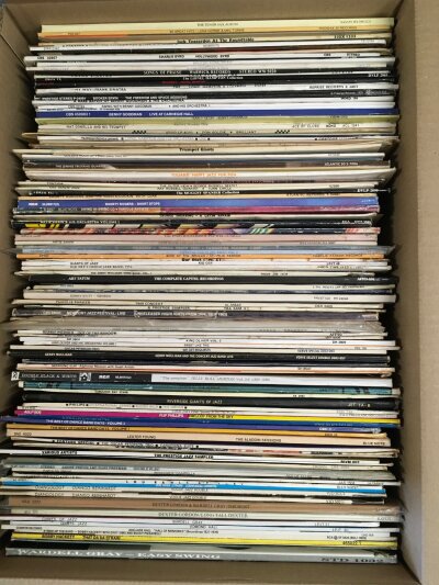 Two boxes and a bag of jazz LPs by various artists including Charlie Parker, Count Basie, Django Reinhardt, Dizzy Gillespie and many more.