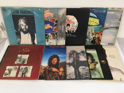 Two bags containing twenty rock LPs by various artists including Queen, Rolling Stones, The Who and others.