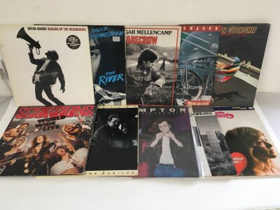 Two bags containing twenty rock LPs by various artists including Scorpions, Bryan Adams, John Cougar Mellencamp and others.
