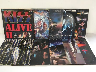 Two bags containing twenty rock LPs by various artists including Kiss, Motörhead, Meat Loaf and others.