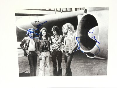 A Jimmy Page and Robert Plant signed photo of Led Zeppelin mounted on card with UACC registered COA, approx 29.5cm x 21cm.