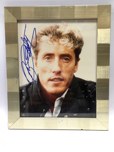 A framed and glazed Roger Daltrey signed photo, no COA. Approx 25.5cm x 30cm.