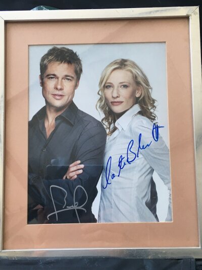 A framed and glazed siged photo of Brad Pitt and Cate Blanchett, approx 27cm x 32cm.