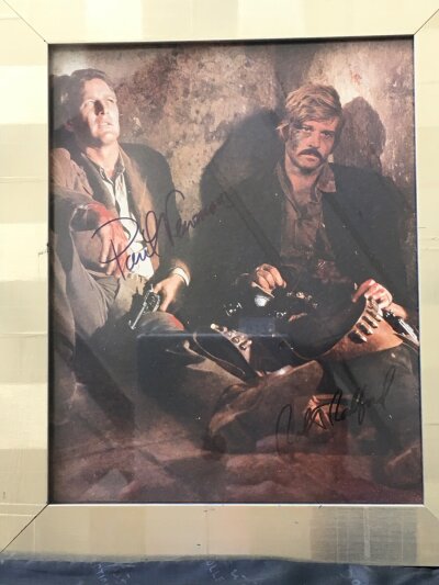 A framed and glazed Paul Newman and Robert Redford signed photo, approx 25cm x 30.5cm including frame.