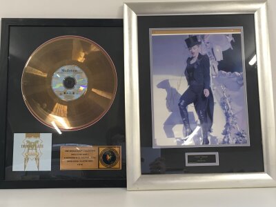 A framed and glazed signed Madonna photo with COA from a UACC registered dealer and a framed and glazed Immaculate Collection gold disc (2).