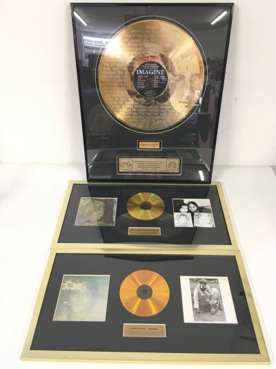A framed limited edition John Lennon Imagine gold disc display with a small section of the doors from Tittenhurst Park included. Comes with two further framed CD displays of Imagine and Plastic Ono Band (3).
