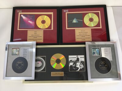 A collection of framed CD displays for various artists including Queen, David Bowie, Pink Floyd and The Rolling Stones.