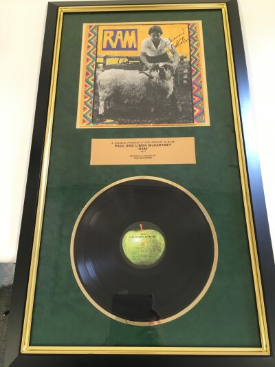 A framed and signed Paul McCartney presentation display for the Ram LP, Our Price PLC COA included. Approx 54cm x 95cm.