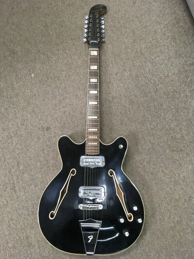 A Fender Coronado XII 12 string electric guitar in black. Stamped SPECIAL on rear of headstock. Missing scratchplate. 183190 on neck plate. Comes with a hard carry case.