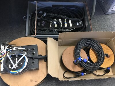 A collection of studio/live equipment comprising a stage box, Peavey audio link, various heavy duty leads etc.