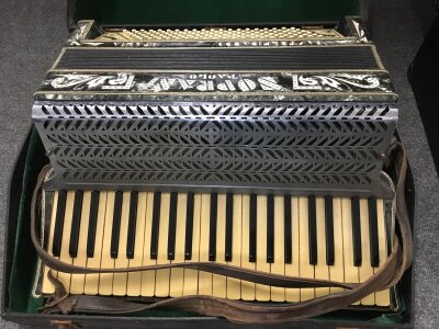 A Paolo Soprani piano accordion in a fitted case.