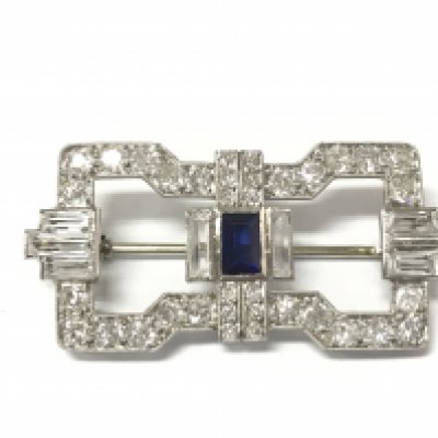 An art deco brooch in white metal set with old cut diamonds and further white and blue gemstones. Postage A
