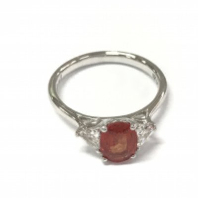 Platinum trilogy ring set with a central oval orange sapphire flanked by diamonds. Sapphire 1.37ct and diamonds 0.37ct. Size N