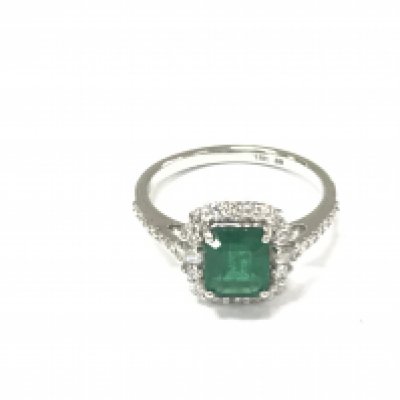 An 18ct white gold step cut emerald ring with round and baguette cut diamond border with further diamonds to the shoulders. Emeralds 1.13ct and diamonds 0.47ct approximately. Size N