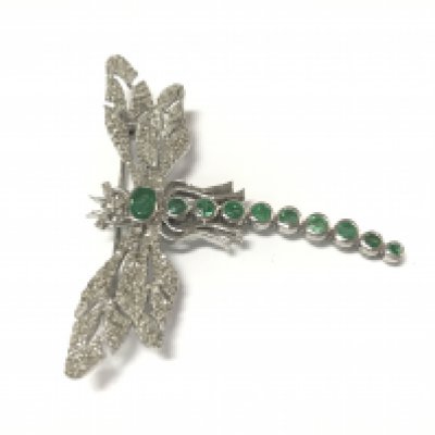 A silver dragonfly brooch / pendant set with emeralds and diamonds. Emeralds 1.34ct and diamonds 1.18ct approximately.