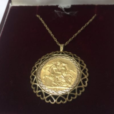 A 1912 full sovereign and chain, 14g total weight. Postage category A