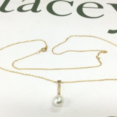 An 18ct gold diamond and pearl set pendant on a chain (not gold). Shipping category A.