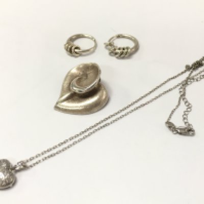 A silver group of jewellery including a silver floral pendant, earrings, heart pendant necklace. postage category A
