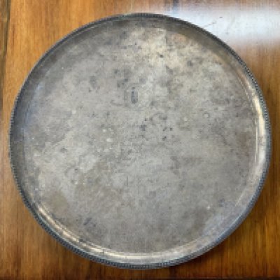 A large hallmarked silver 4 footed serving tray, 1.78kg, Vander & Hedges Tessiers Ltd. (Ref Lot 701, Estate of Alderman L Miles), presented by Sir Josiah C Stamp GBE, London, Midland and Scottish railway company on the opening of Leigh on Sea station. Diameter 38cm x 3.5cm